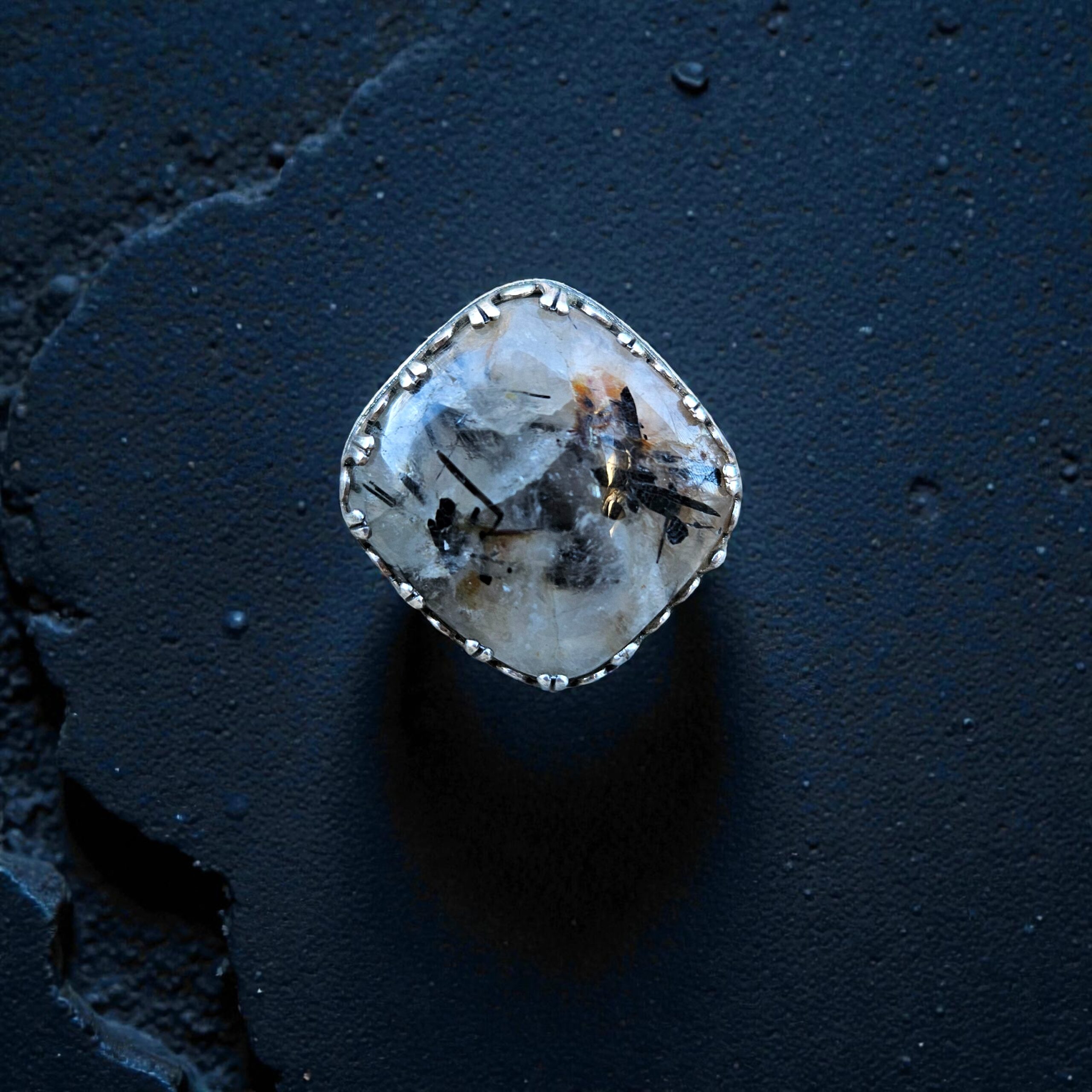 A bold 25mm square Tourmalinated Quartz cabochon set on point in a diamond orientation, featured in a polished sterling silver ring.