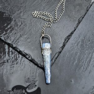 Blue Kyanite sceptor set in sterling silver photographed on a black slate stone background.