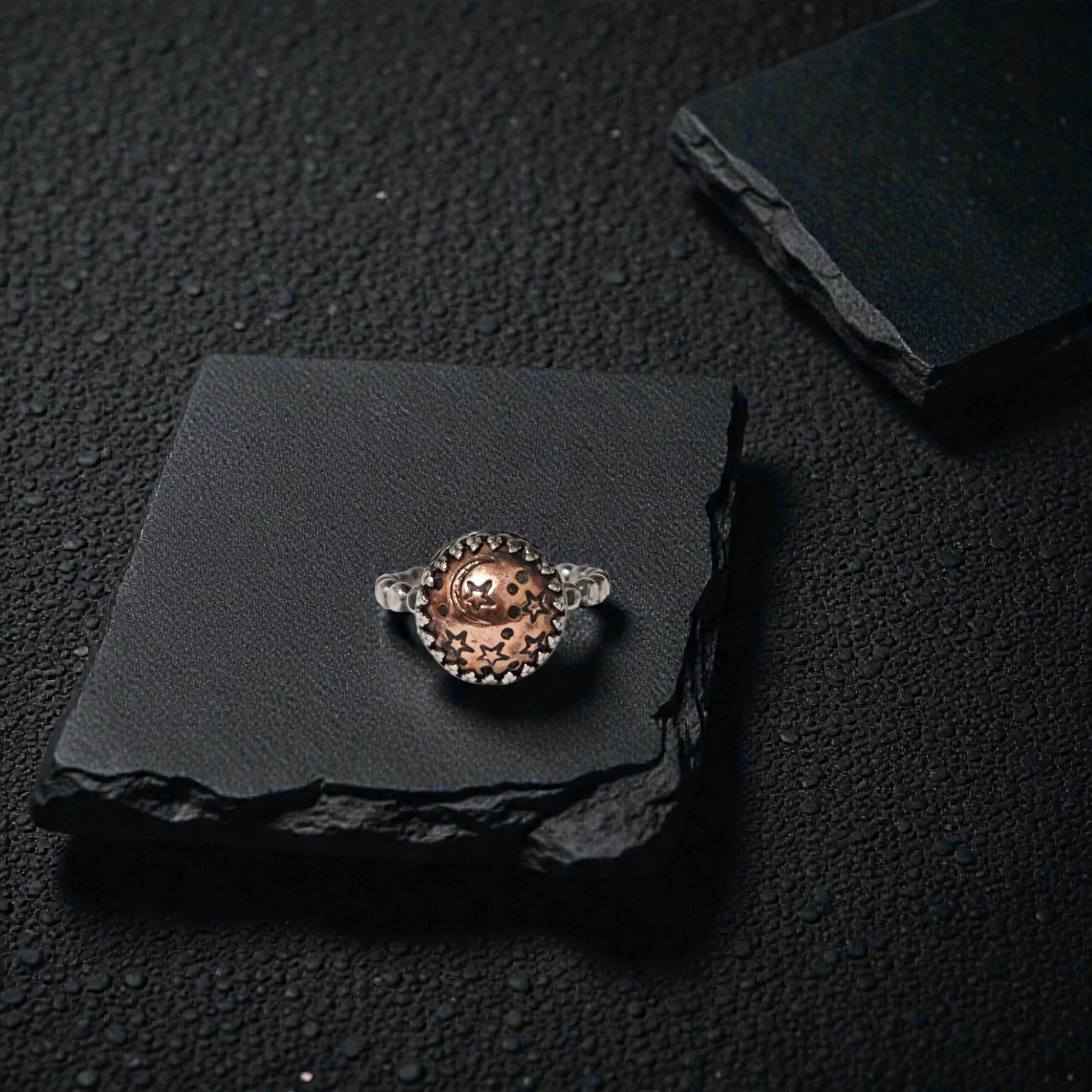 Small copper celestial dome ring with a crowned sterling silver bezel and hand-stamped moon and stars.