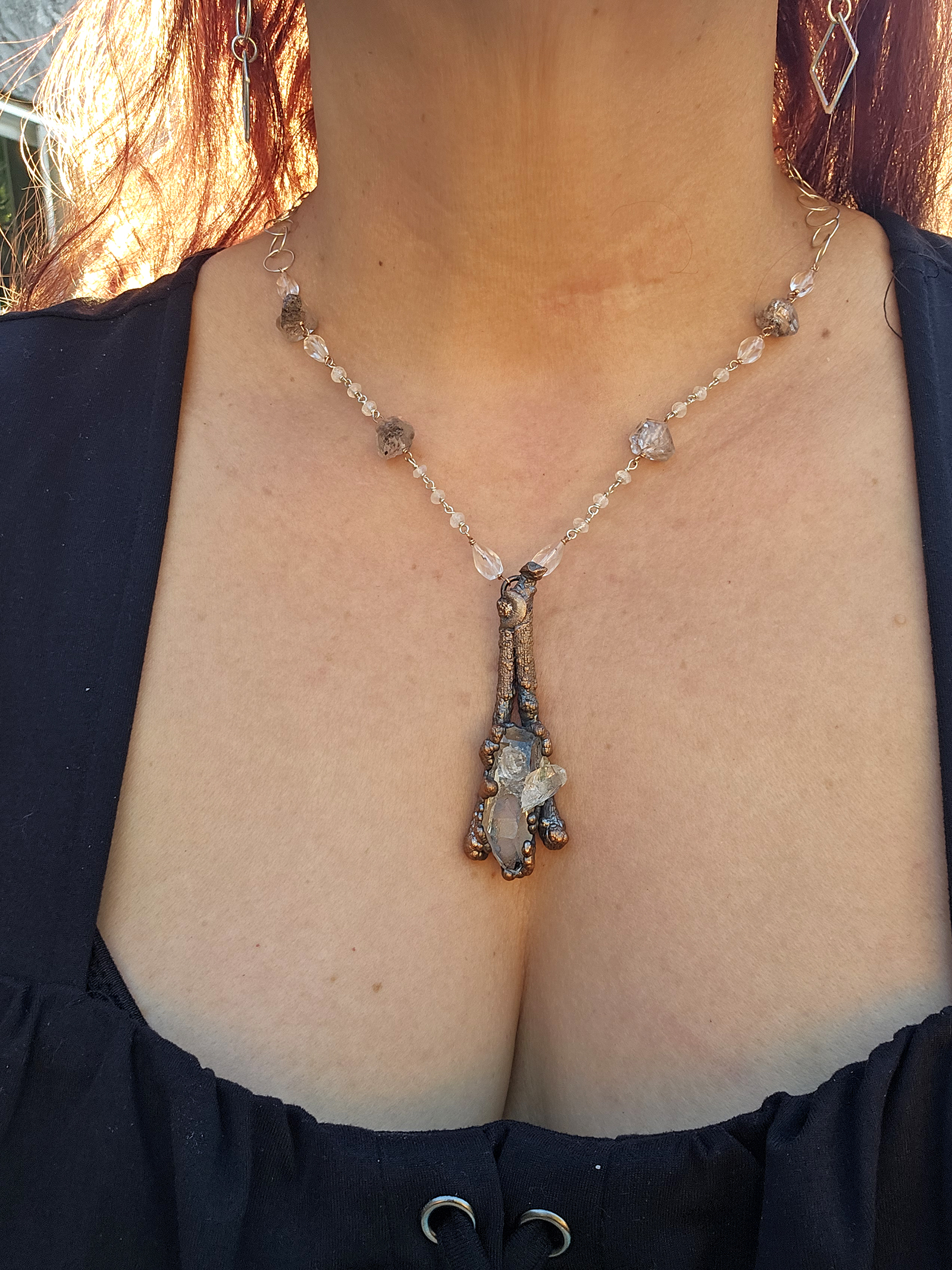 The full length of the 20-inch artisan necklace, highlighting the meticulously hand-beaded rosary chain made of sterling silver, copper, and quartz.