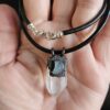 Close up of Labradorite and Quartz amulet shown in hand