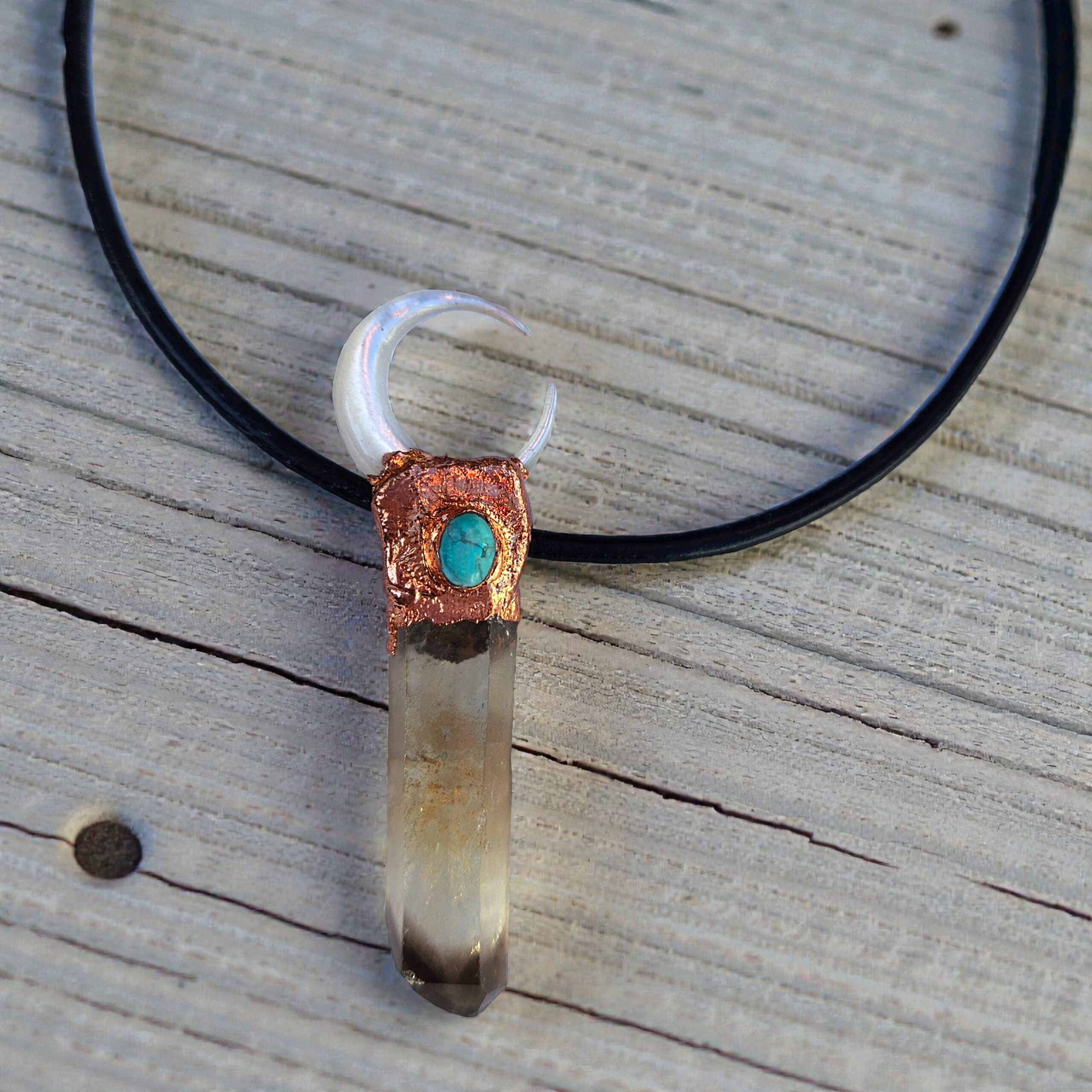 Close-up of the "ink-tipped" smoky quartz and the intricate copper bezel holding the turquoise and pearl moon.