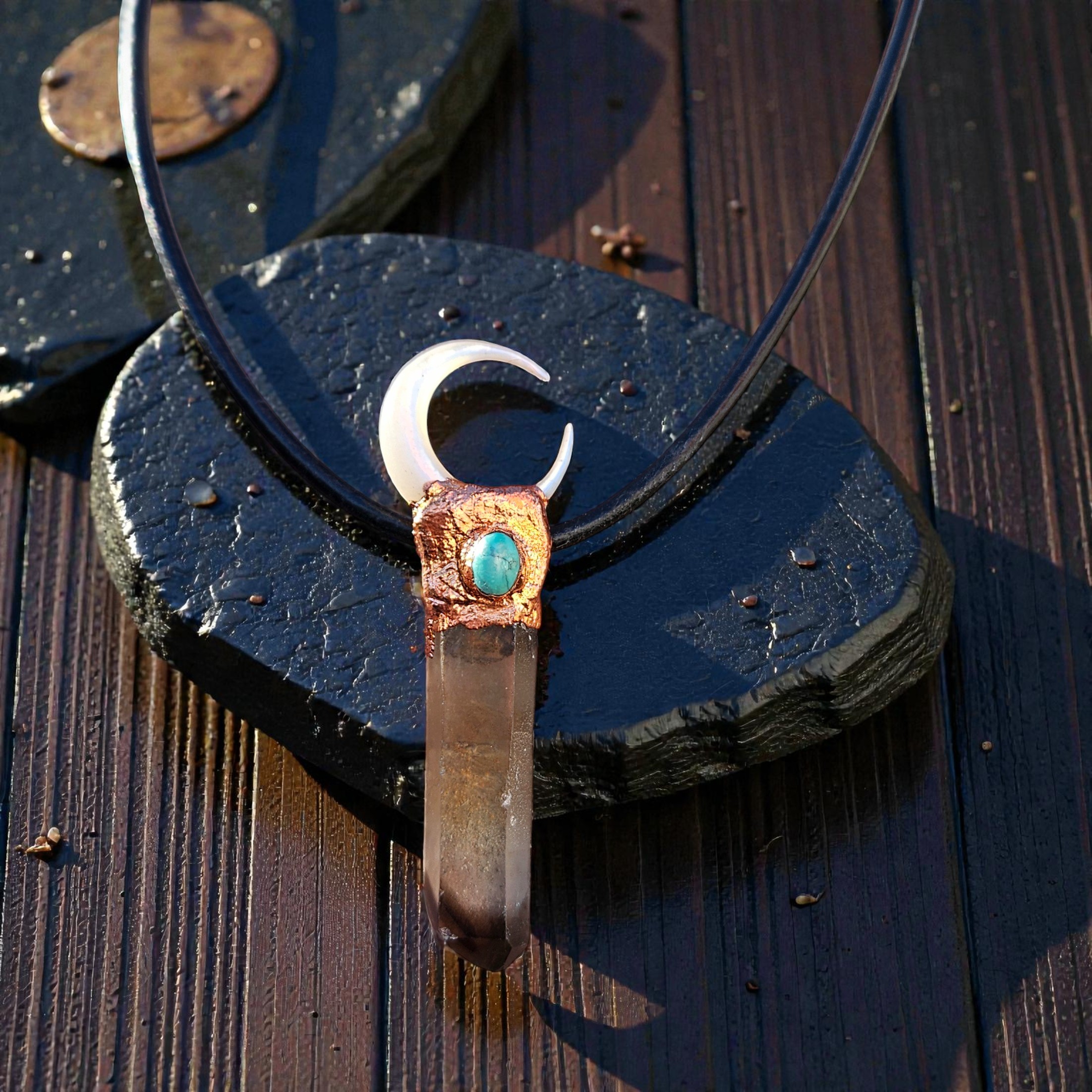 Close-up of the "ink-tipped" smoky quartz and the intricate copper bezel holding the turquoise and pearl moon.