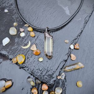Smokey Quartz talisman hanging from a leather cord.