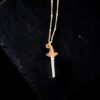 Handcrafted copper electroformed witch hat necklace with a long, clear quartz crystal point as the peak. The pendant is shown against a dark slate background, attached to a rose gold filled chain.