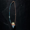 A focused product photo highlighting the entire 17-inch necklace layout, showing the clean transition from the heavily detailed gemstone and shell strand on one side to the sleek copper link chain on the other.