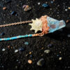 Close-up macro photograph highlighting the meticulous, hand-grown copper textures cradling the multi-pointed aqua aura quartz cluster and the delicate ridges of the star shell centerpiece.