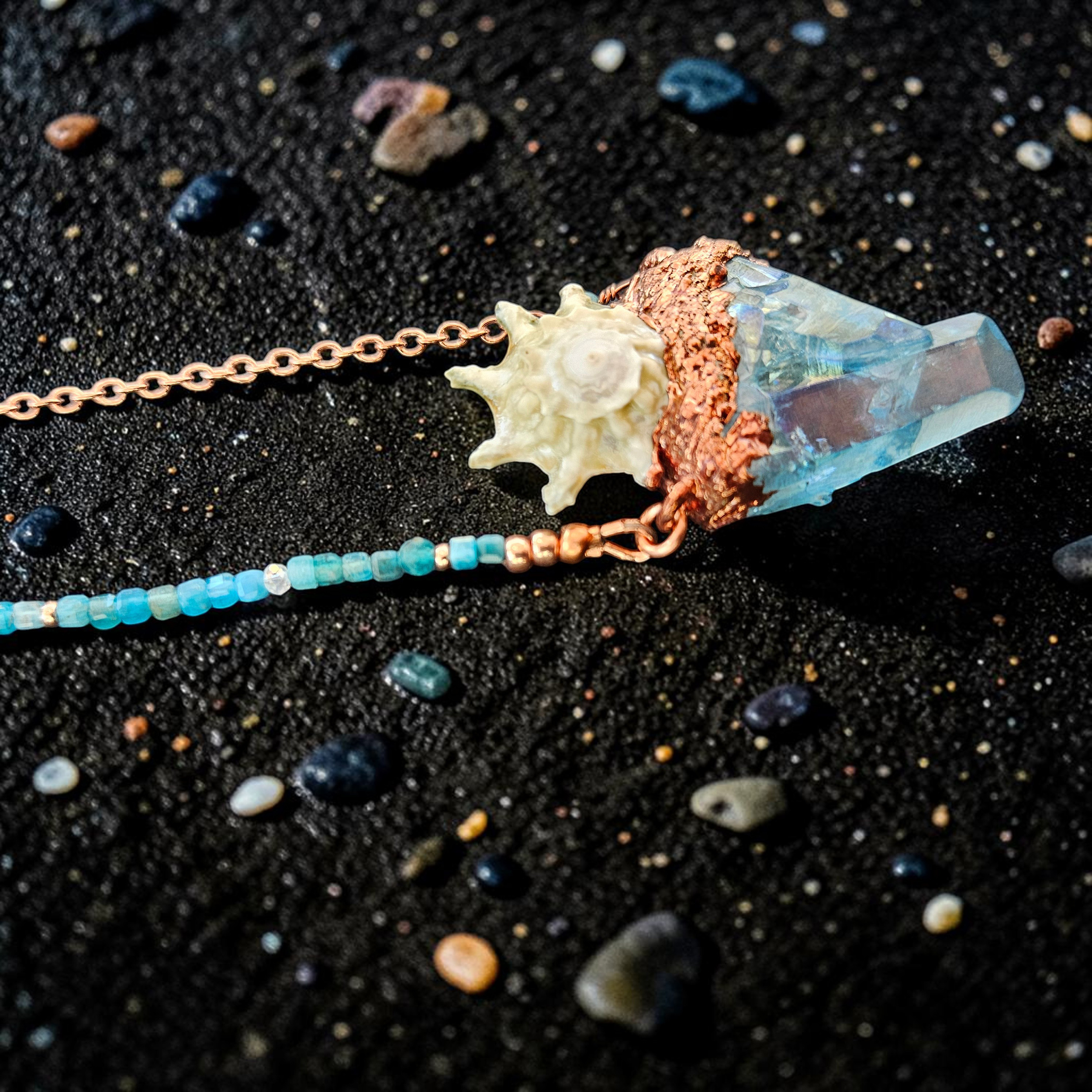 Close-up macro photograph highlighting the meticulous, hand-grown copper textures cradling the multi-pointed aqua aura quartz cluster and the delicate ridges of the star shell centerpiece.