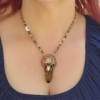 A modeled shot demonstrating the 2.5-inch drape of the smoky quartz talisman against a navy blue neckline, showing how the asymmetrical crescent moon sits elegantly on the left collarbone.